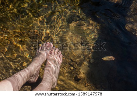 Soaking one's feet in the water of the stream Stock fotó © 