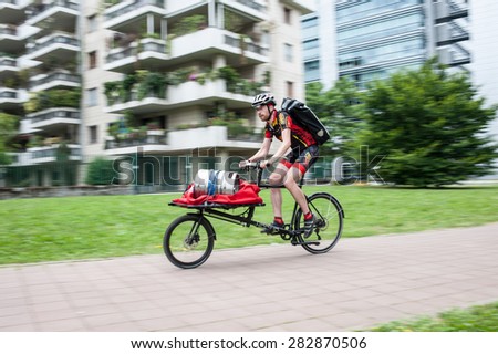 Milan, may 31, 2015 - Urban messenger competes with a cargo bike in the European Cycle Messenger Championship, disputed on an urban circuit of Milan.