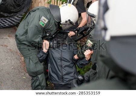 GARMISCH-PARTENKIRCHEN, GERMANY - JUNE 06: Anti-G7 protester arrested by police officers during the demonstration held the day before the summit of G7 leaders.