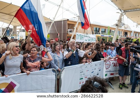 MILANO, JUNE 10, 2015: Supporters of President Vladinir Putin shout slogans outside Expo Milan 2015 in Italy during the visit at Expo Milan 2015 of the President of Russia.
