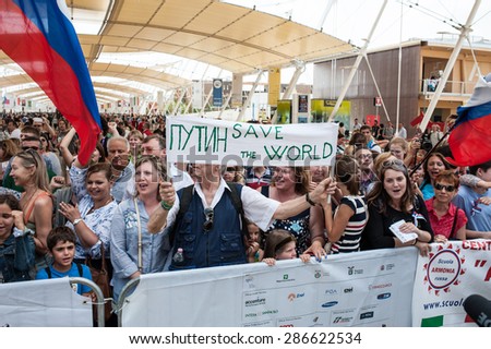 MILANO, JUNE 10, 2015: Supporters of President Vladinir Putin shout slogans outside Expo Milan 2015 in Italy during the visit at Expo Milan 2015 of the President of Russia.