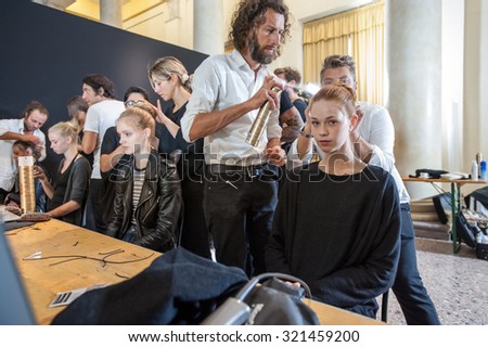 MILANO, ITALY - SEPTEMBER 25, 2015: A model gets her hair done ahead of the Uma Wang catwalk during the presentation of spring-summer collection 15/16 at Milan Fashion Week  2015.