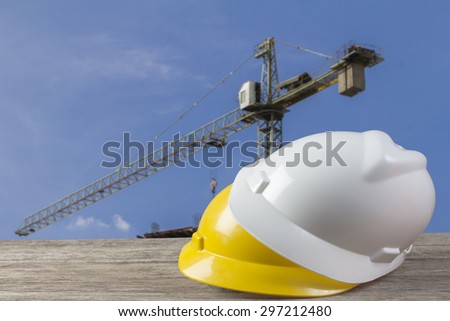safety helmet and architect plant on wood table with  construction