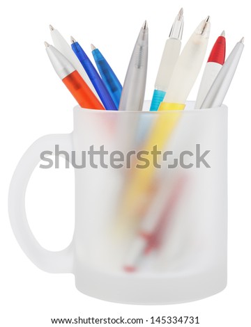 Pens are kept in mug. Object is isolated on white background without shadows.