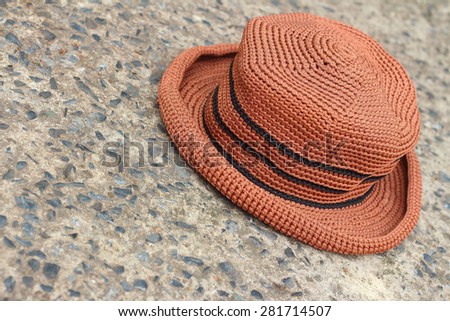 Brown hat on a background of cement.