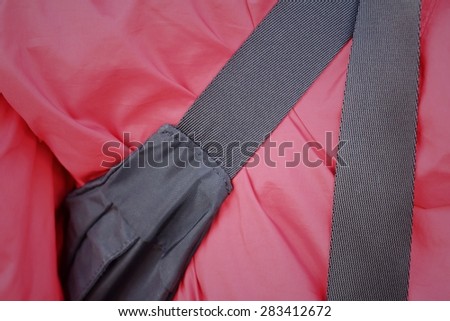Bag strap on a red shirt of teenage