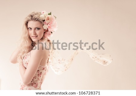 portrait of beautiful girl in thin dress with rose in hair