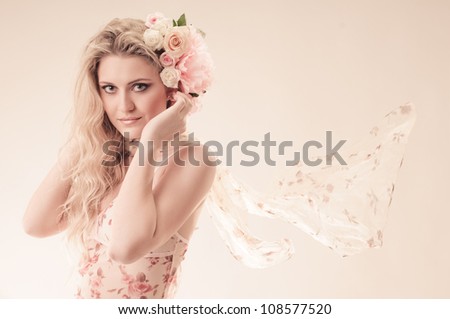 portrait of beautiful girl in thin dress with rose in hair