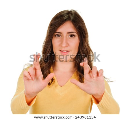 portrait of a young pretty happy woman crossing fingers wishing, praying, christening. isolated on white background. Positive emotions facial expression feelings
