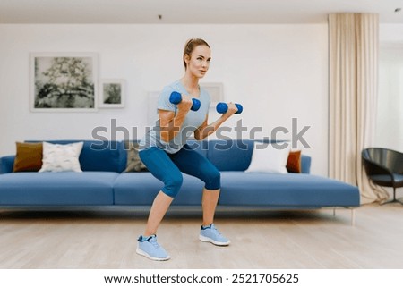 Similar – Image, Stock Photo Focused sportswoman doing squats with elastic band in apartment