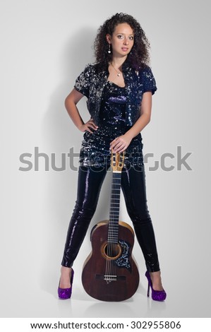 beauty woman player with classical guitar full length on grey