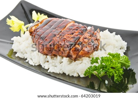 black plate with chicken and rice on white