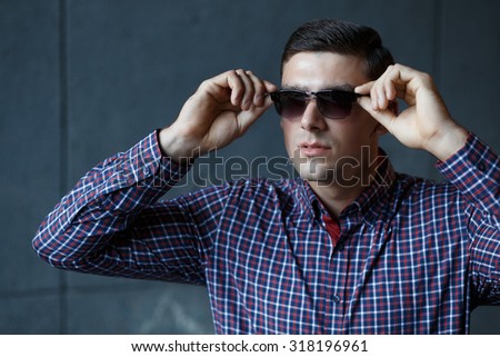 Stylish man in checkered shirt dress sunglasses