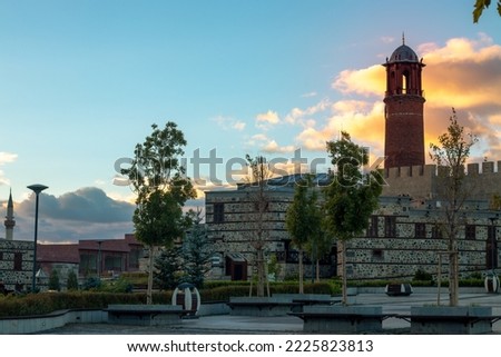 Clock tower of Erzurum castle at sunset. Anatolian stone houses. Erzurum stone houses. Historic stone houses. Anatolian architectural building examples.Selective focus. Stock foto © 