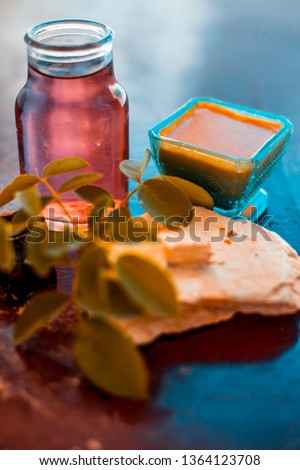 Face pack of devil's dung powder on wooden surface i.e. Hing powder well mixed with mulpani mitti or fuller's earth and rose water.Used for the treatment of Acne and pimples. Photo stock © 