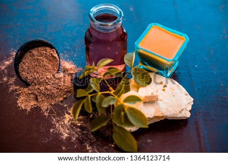 Face pack of devil's dung powder on wooden surface i.e. Hing powder well mixed with mulpani mitti or fuller's earth and rose water.Used for the treatment of Acne and pimples. Photo stock © 