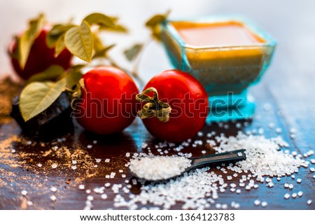 Face pack of hing or Asafoetida on wooden surface i.e. Hing powder well mixed with tomato pulp and sugar.For the treatment of skin whitening,.All the ingredients present on the surface. Photo stock © 