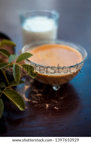 Face pack for anti-dryness on wooden surface i.e. Hing powder well mixed with honey and milk in a bowl and entire raw ingredients present on the surface. Photo stock © 