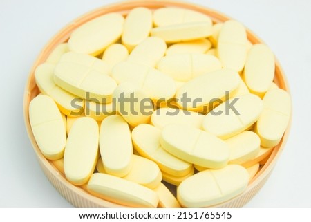A pile of calcium and vitamin D supplement tablets isolated on a white background Stock fotó © 