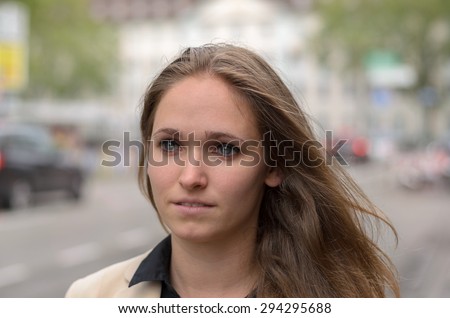 Close up Pretty Face of a Blond Young Woman at the Street Looking Into Distance with Thoughtful Facial Expression.