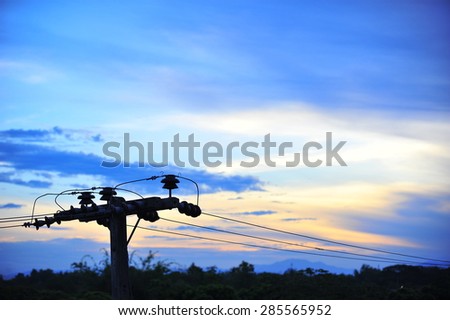 Electricity post on blue sky background in a village.