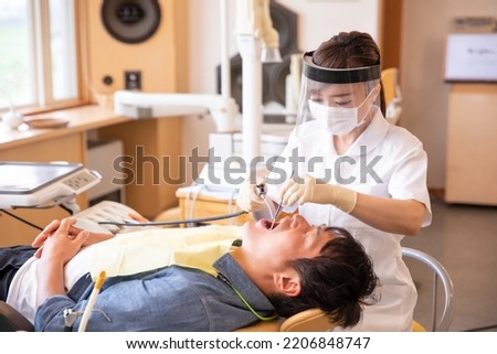 Treating dentist (dental assistant, dental hygienist) Foto d'archivio © 