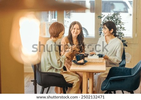 Similar – Image, Stock Photo Asian woman with coffee talking smartphone at cafe table