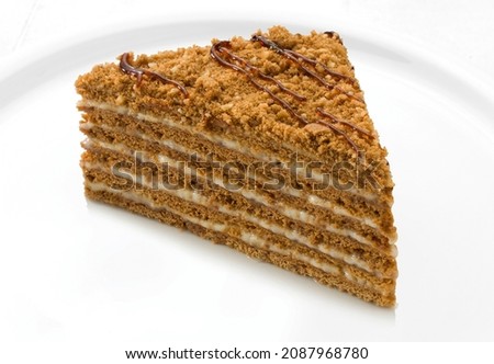 Honey cake slice white plate isolated background. 
