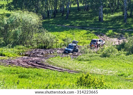 Berdsk, Russia, Siberia - July 7, 2015: the car stuck in the mud while crossing a small river