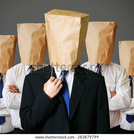army of businessman with a paper bag on head