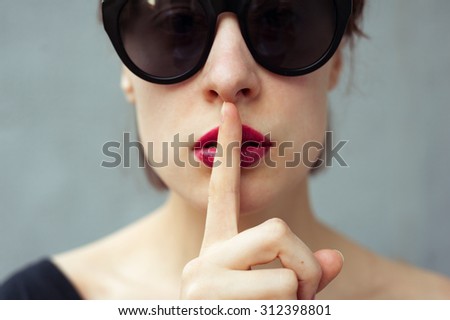 mysterious nice girl asking for silence
