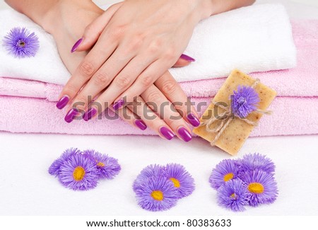 Spa manicure treatment with purple flowers and herbal soap