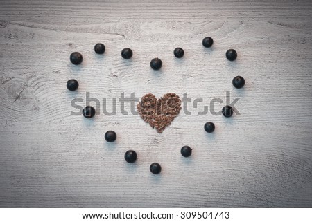 the heart of the seeds in the heart of the currant berries lie on the wood background