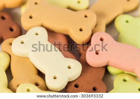 Delicious Pile of dog biscuits in the shape of a bone for pet food background use