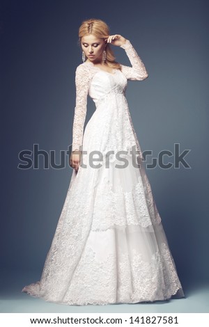 beautiful bride in wedding dress on blue background