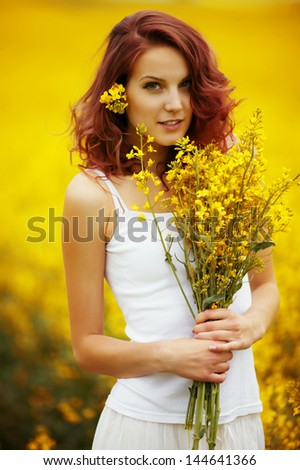 young beautiful girl in yellow field