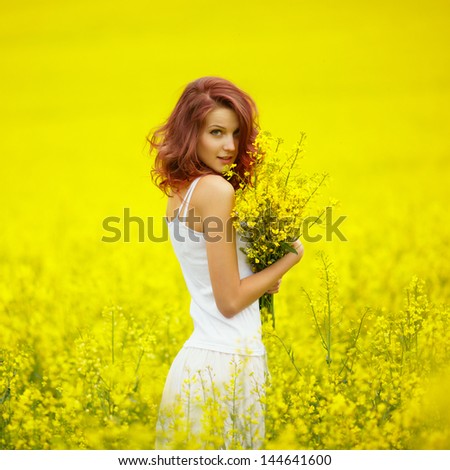 young beautiful girl in yellow field