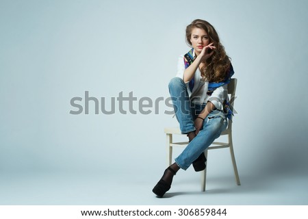 beautiful girl with long hair posing on chair