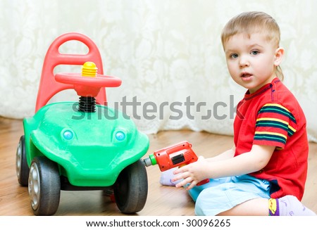 little boy repairs auto