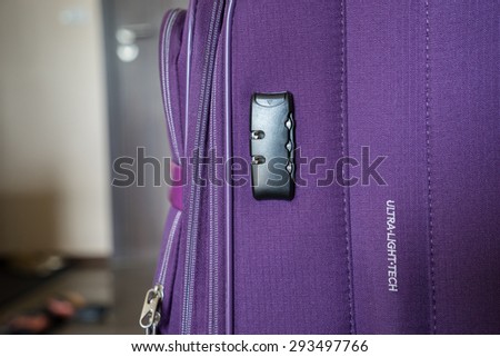 purple luggage in the room