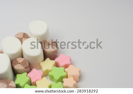 MULTI-SHAPED SMALL MARSHMALLOWS IN WHITE BACKGROUND