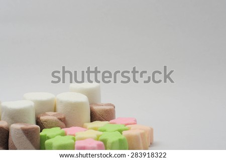 MULTI-SHAPED SMALL MARSHMALLOWS IN WHITE BACKGROUND