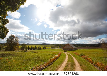 Autumn landscape with a road and house