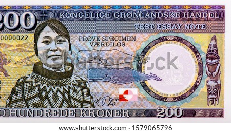 Young Greenlandic Inuit woman. Portrait form Greenland 200 Kroner 2018 Polymer Banknotes, Young Greenlandic Inuit woman. Whale outline and silhouette. Tupilaq. Flag of Greenland. Collection.