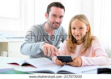 View of a Father helping out her daughter for homework