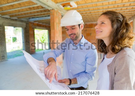 View of a Young woman and architect on construction site