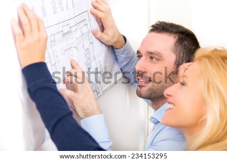 View of a Young couple studying plans of their future house