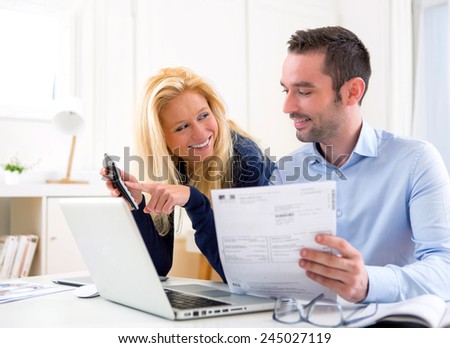 VIew of a Young attractive couple doing administrative paperwork