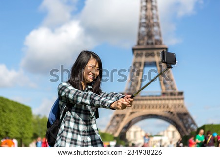View of a Young attractive asian tourist in Paris taking selfie