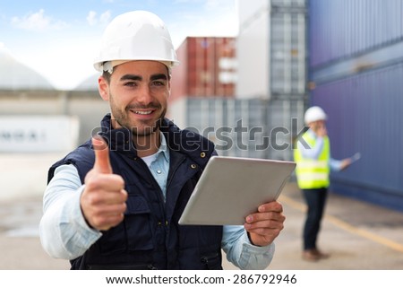 View of a Young Attractive docker using tablet at work